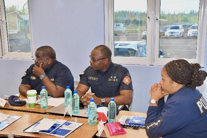 Three Royal Bahamas Police Force participants in discussion during the course.