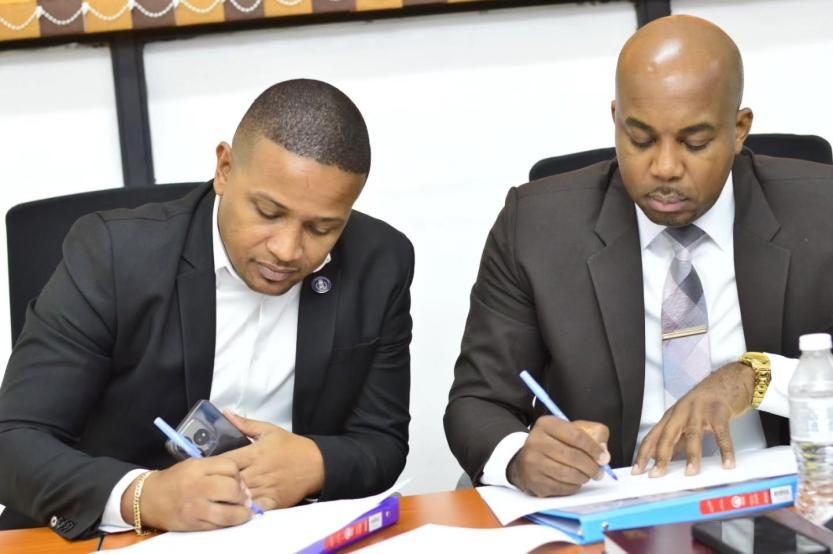 Two JCF participants working on lesson materials at a table.